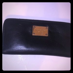 Authentic Michael Kors black leather zip wallet.